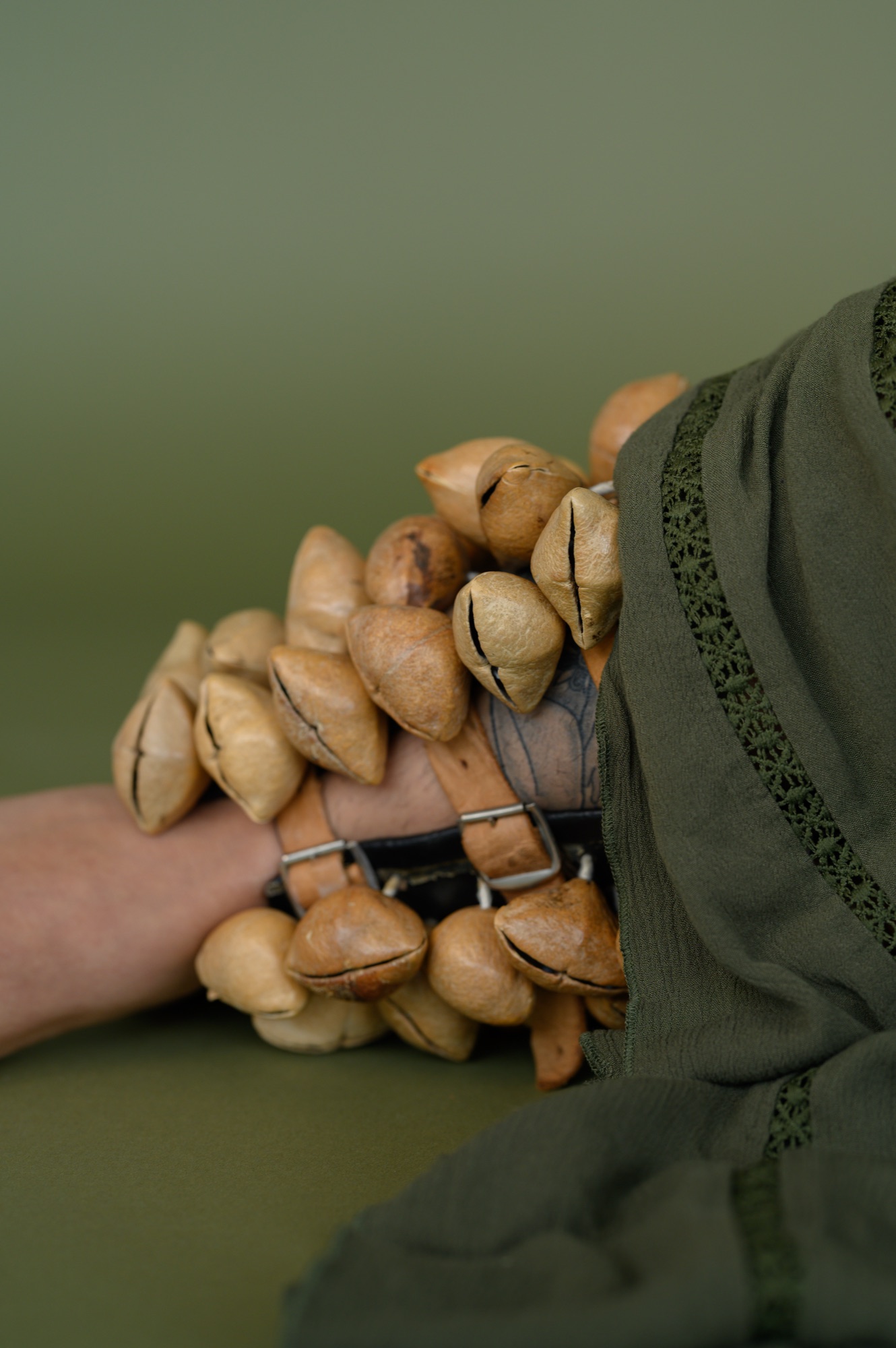Detail of ayayotes, traditional seed rattles, at Frida Alvarez's ankle