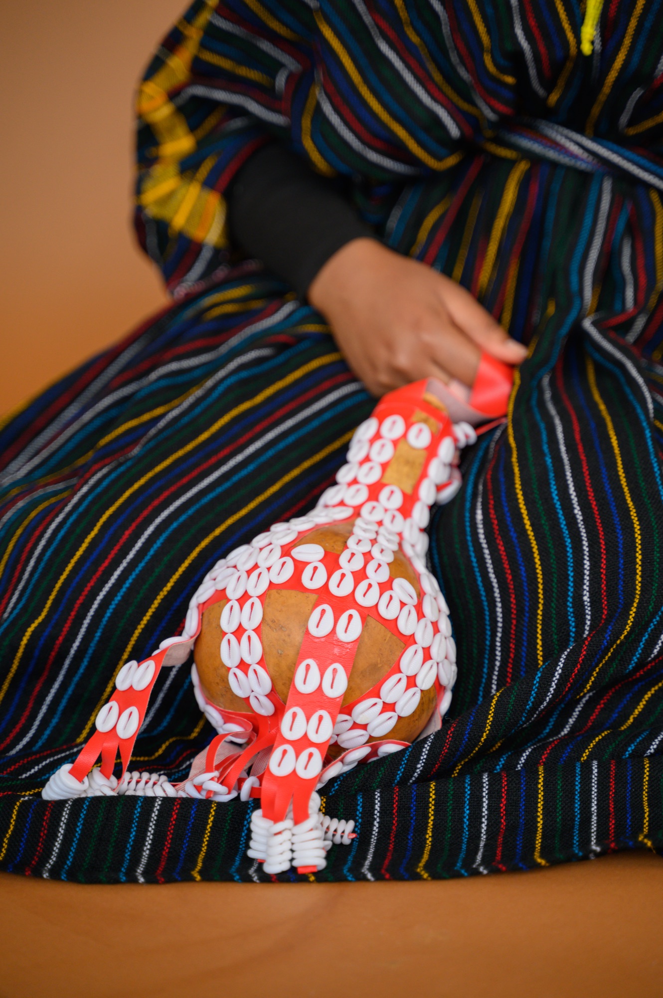 Detail of Faaya Adem's hands and a woven basket, Oromo aadaa attire