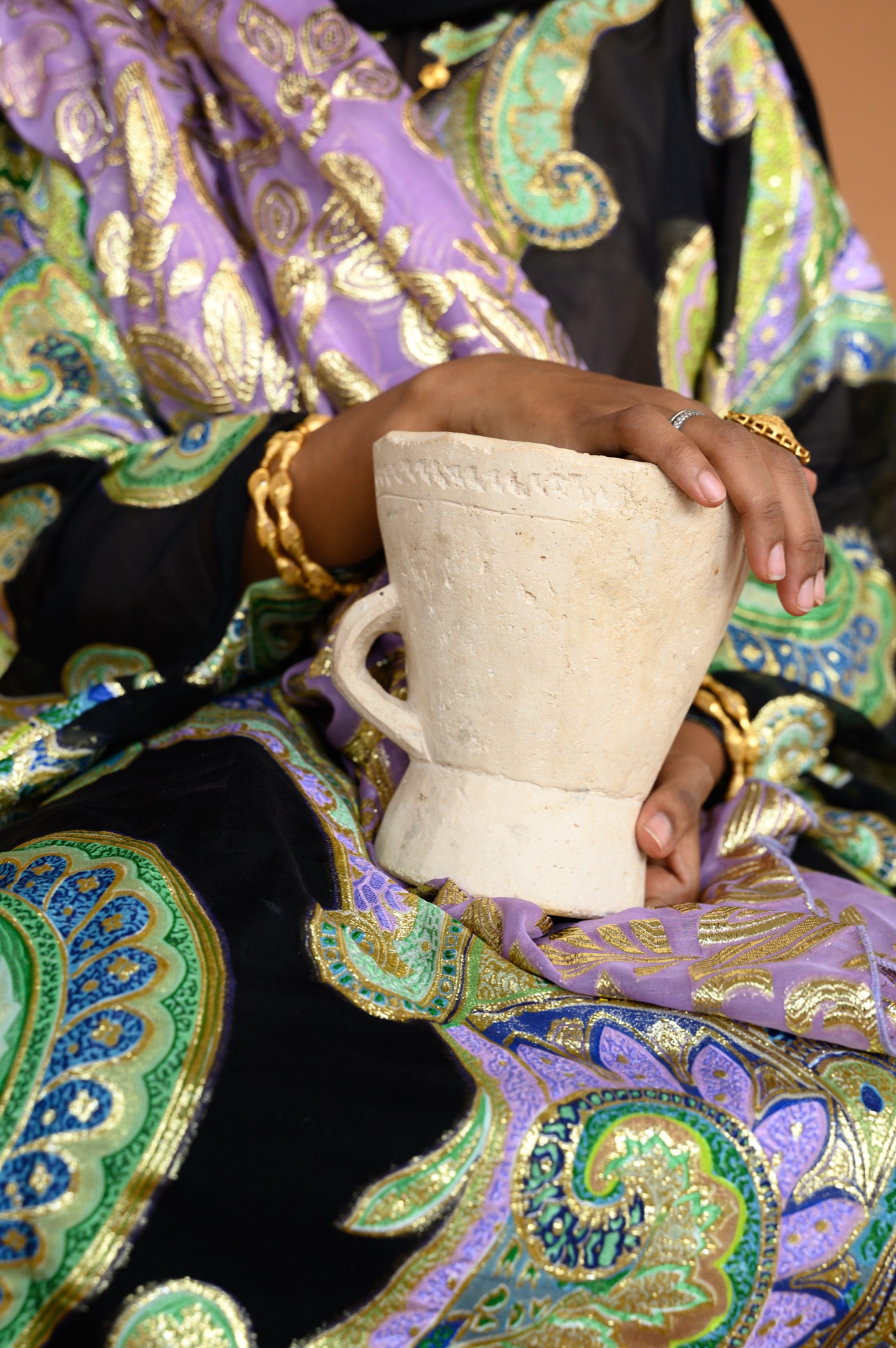 Detail of Mariam Mohamed's hands holding a Dabqaad incense burner