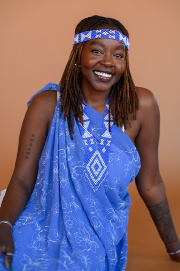 Nyalat Dojiok in a blue lawa and beaded tik headband