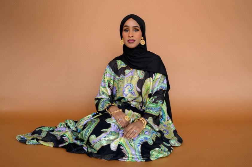 Mariam Mohamed seated in a Dirac and black hijab