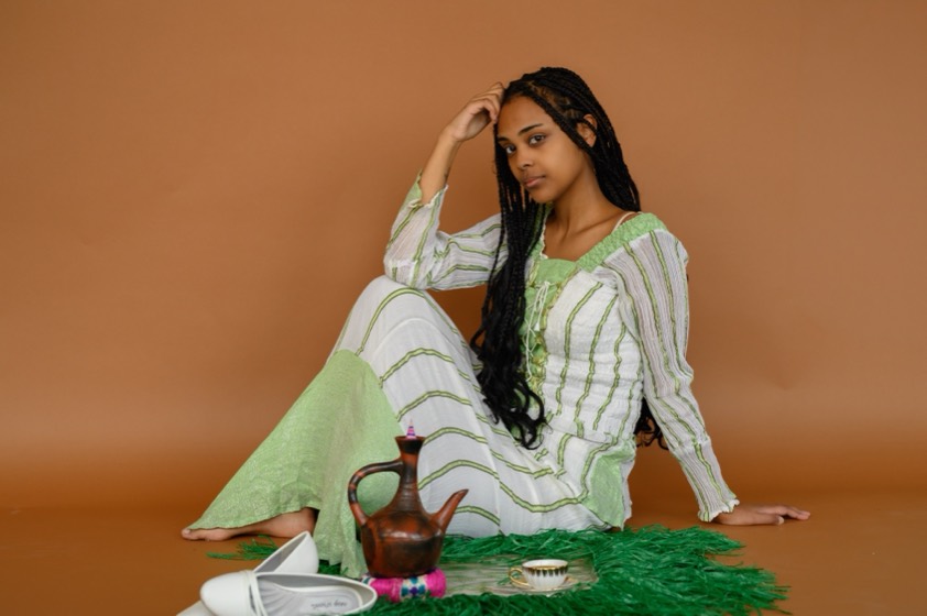 Portrait of Sosina Getachew Admasu in Habesha Kemis with a coffee ceremony set